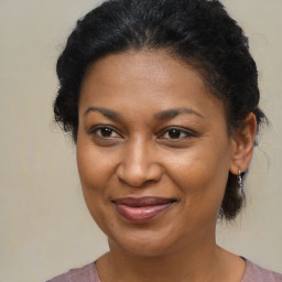 Joyful black young-adult female with medium  brown hair and brown eyes