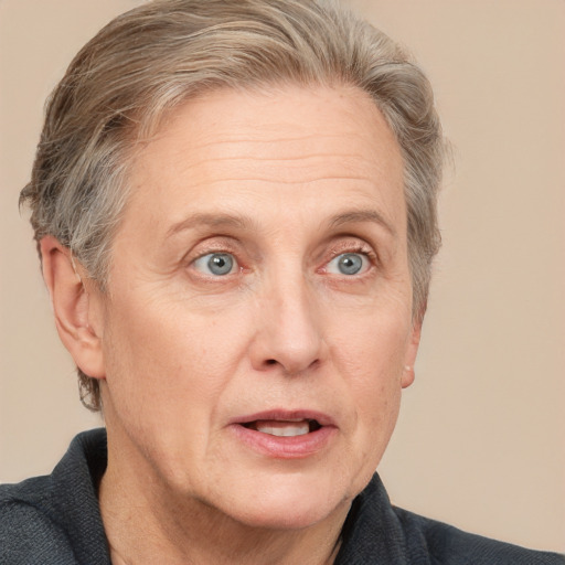 Joyful white middle-aged female with short  brown hair and grey eyes