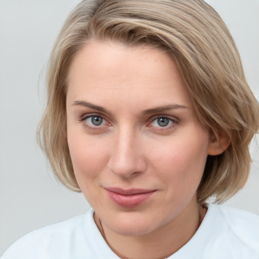 Joyful white young-adult female with medium  brown hair and blue eyes