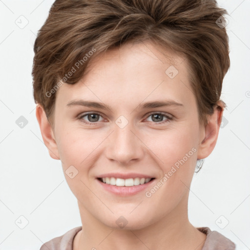 Joyful white young-adult female with short  brown hair and grey eyes