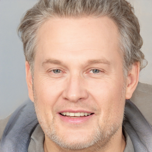 Joyful white middle-aged male with short  brown hair and brown eyes