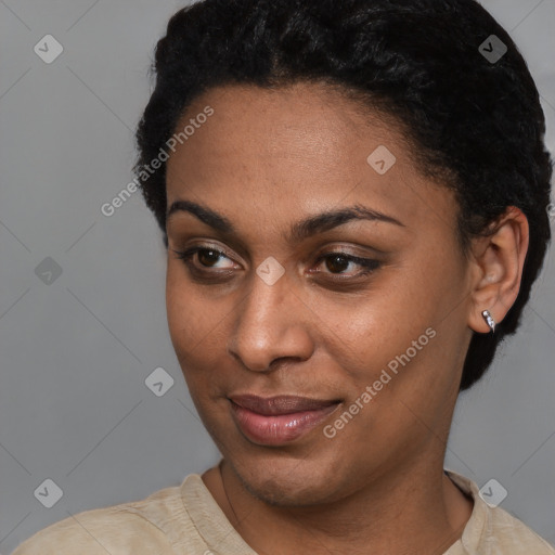 Joyful black young-adult female with short  black hair and brown eyes