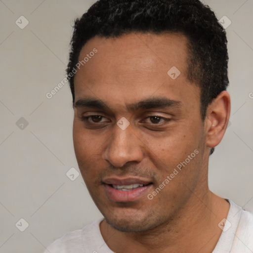 Joyful white young-adult male with short  black hair and brown eyes