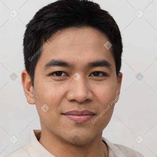 Joyful asian young-adult male with short  black hair and brown eyes