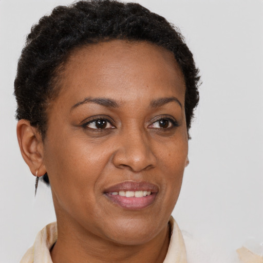 Joyful black adult female with short  brown hair and brown eyes