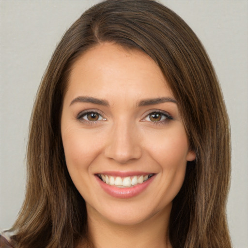 Joyful white young-adult female with long  brown hair and brown eyes