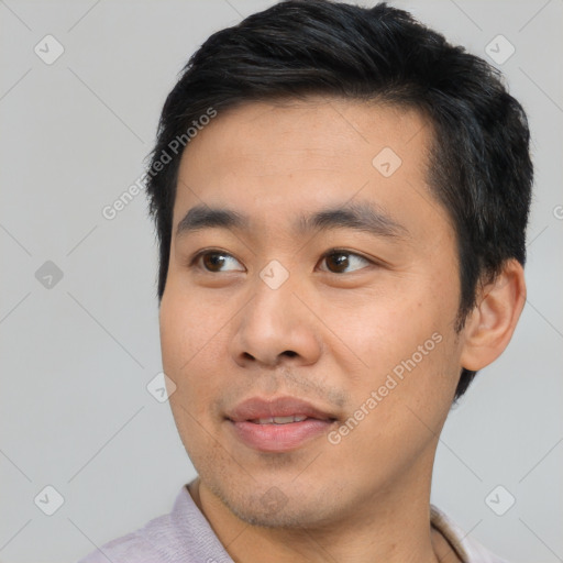 Joyful asian young-adult male with short  black hair and brown eyes