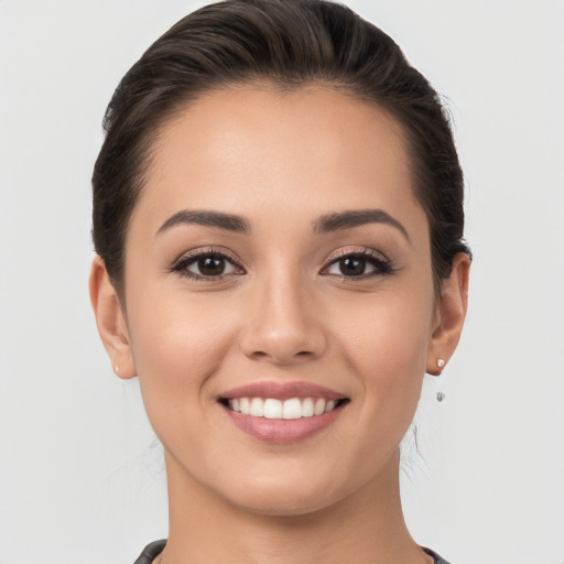 Joyful white young-adult female with long  brown hair and brown eyes