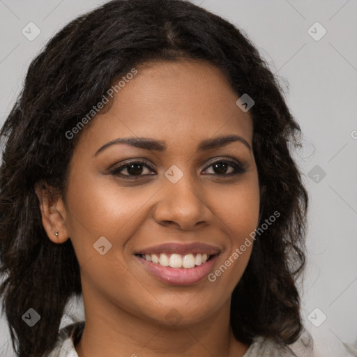 Joyful black young-adult female with long  brown hair and brown eyes