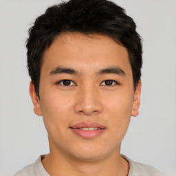 Joyful asian young-adult male with short  black hair and brown eyes