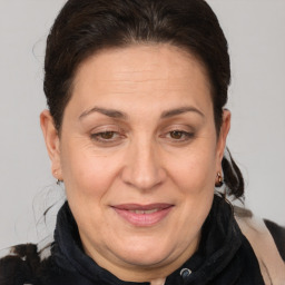 Joyful white adult female with medium  brown hair and brown eyes