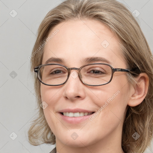 Joyful white adult female with medium  brown hair and blue eyes