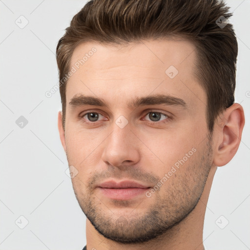 Joyful white young-adult male with short  brown hair and brown eyes