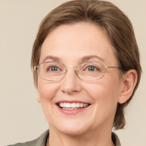 Joyful white adult female with medium  brown hair and blue eyes