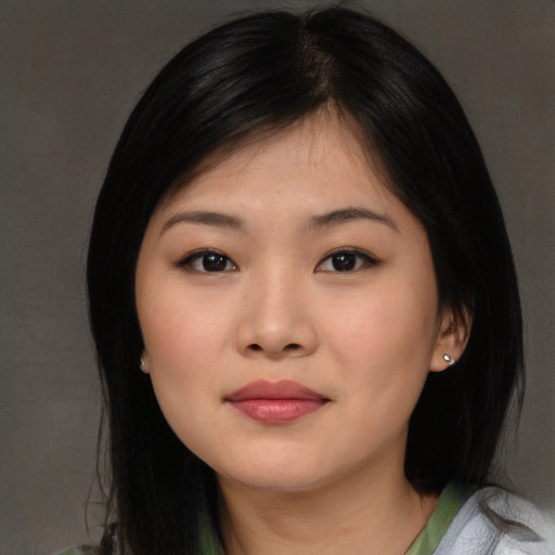 Joyful asian young-adult female with medium  black hair and brown eyes