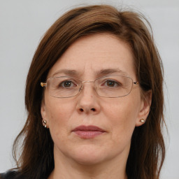 Joyful white adult female with long  brown hair and brown eyes