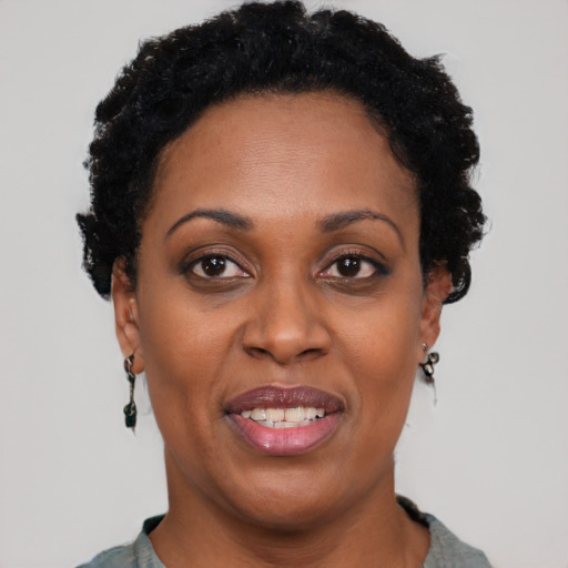 Joyful black adult female with short  black hair and brown eyes