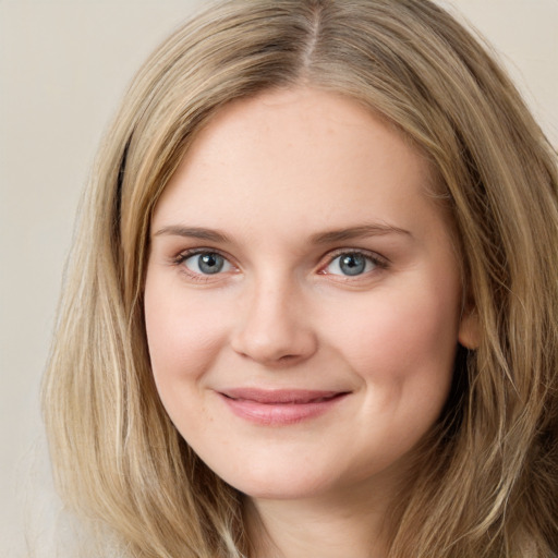 Joyful white young-adult female with long  brown hair and green eyes