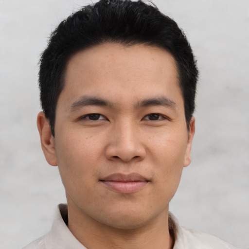 Joyful asian young-adult male with short  brown hair and brown eyes