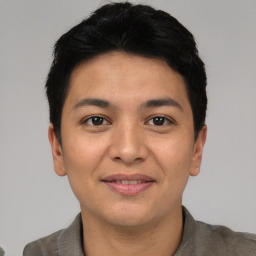 Joyful asian young-adult male with short  black hair and brown eyes