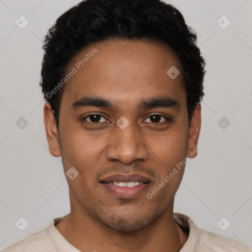 Joyful black young-adult male with short  black hair and brown eyes