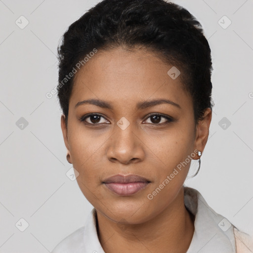 Joyful black young-adult female with short  black hair and brown eyes