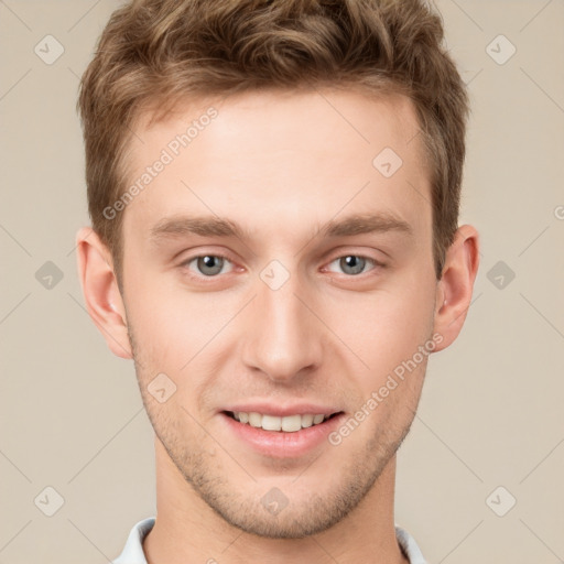 Joyful white young-adult male with short  brown hair and grey eyes