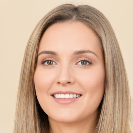 Joyful white young-adult female with long  brown hair and brown eyes