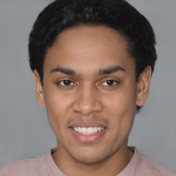 Joyful latino young-adult male with short  black hair and brown eyes