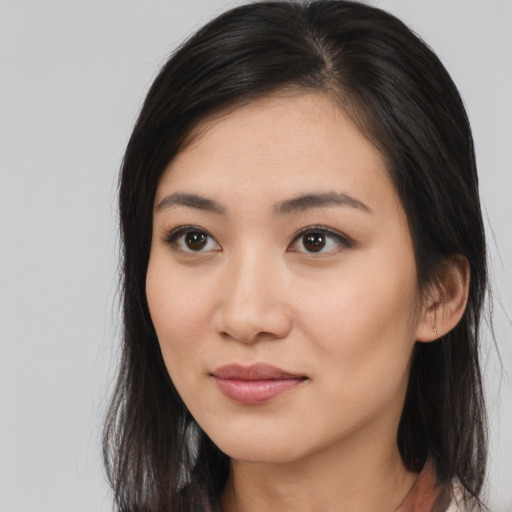 Joyful asian young-adult female with medium  brown hair and brown eyes