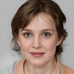 Joyful white young-adult female with medium  brown hair and blue eyes