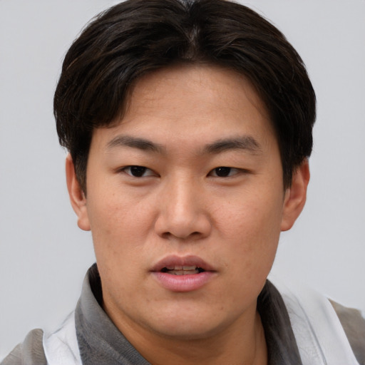Neutral asian young-adult male with short  brown hair and brown eyes