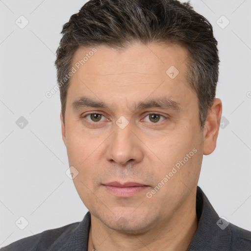 Joyful white adult male with short  brown hair and brown eyes