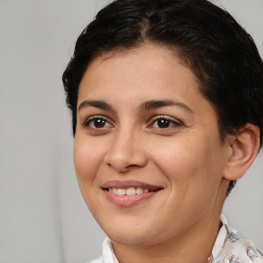 Joyful white young-adult female with short  brown hair and brown eyes