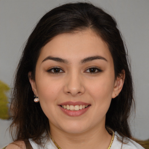 Joyful white young-adult female with medium  brown hair and brown eyes