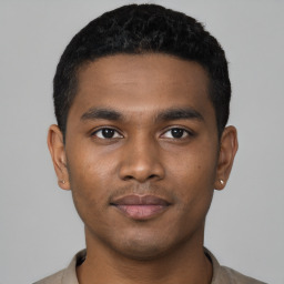 Joyful black young-adult male with short  black hair and brown eyes