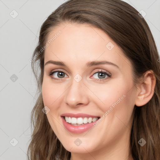 Joyful white young-adult female with long  brown hair and grey eyes