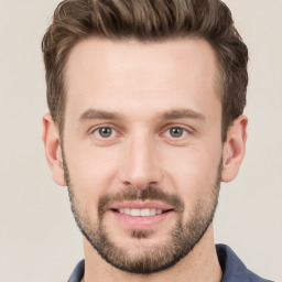 Joyful white young-adult male with short  brown hair and grey eyes