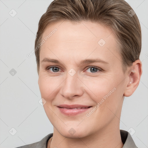 Joyful white young-adult female with short  brown hair and grey eyes