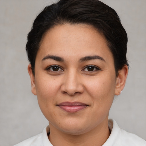 Joyful white young-adult female with short  brown hair and brown eyes