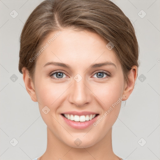 Joyful white young-adult female with short  brown hair and grey eyes