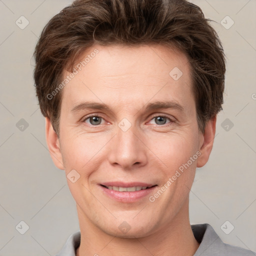 Joyful white adult male with short  brown hair and grey eyes