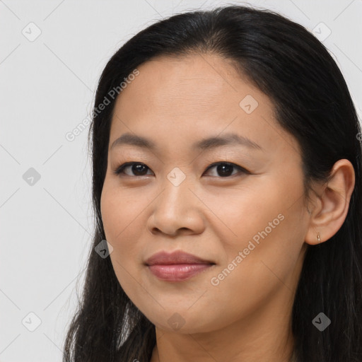 Joyful asian young-adult female with long  brown hair and brown eyes