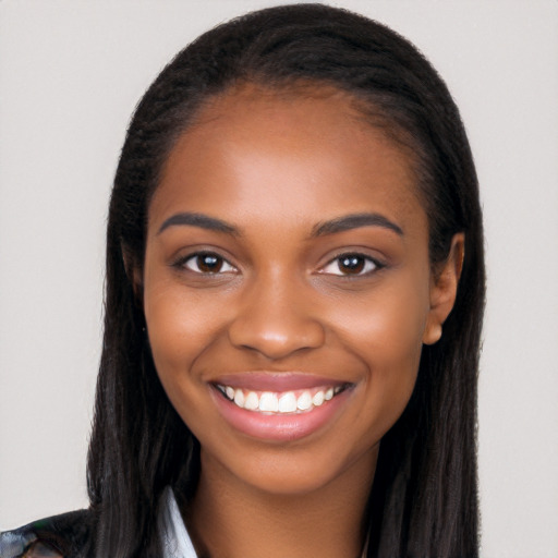 Joyful black young-adult female with long  brown hair and brown eyes