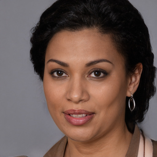 Joyful latino young-adult female with medium  black hair and brown eyes
