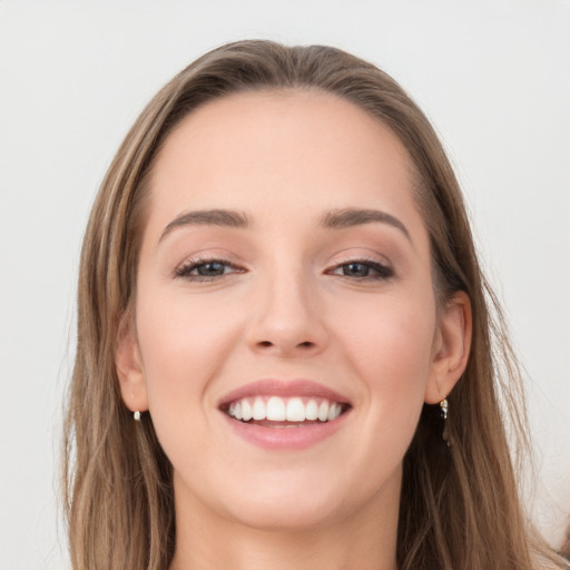 Joyful white young-adult female with long  brown hair and grey eyes