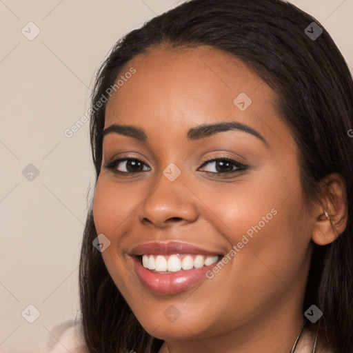 Joyful latino young-adult female with long  brown hair and brown eyes