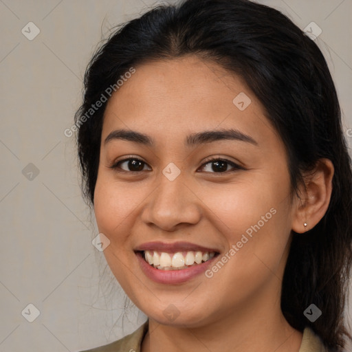 Joyful latino young-adult female with medium  brown hair and brown eyes