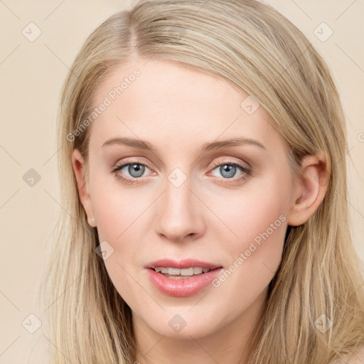 Joyful white young-adult female with long  brown hair and blue eyes