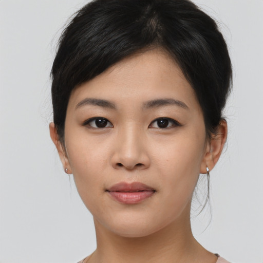 Joyful asian young-adult female with medium  black hair and brown eyes
